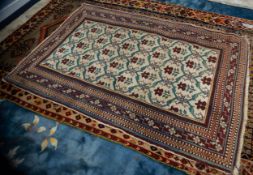 EASTERN RUG with all-over repeat pattern of a crimson bloom on a foliate stem within blue/grey
