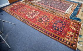 GOREVAN, PERSIAN LARGE RUNNER with five medallion pattern on a red field with fawn and floral