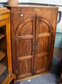 GEORGE III LINE INLAID MAHOGANY LARGE CORNER CUPBOARD enclosed by two arch topped framed three panel