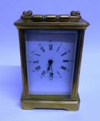 MODERN BRASS CARRIAGE CLOCK, of typical form with white mask and a moulded case with bevelled