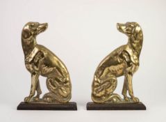 PAIR OF VICTORIAN CAST BRASS DOOR STOPS OR HEARTH DOGS, each on a cast iron oblong gadrooned edge