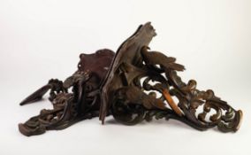 PAIR OF TWENTIETH CENTURY CONTINENTAL CARVED SOFTWOOD WALL BRACKETS, dark stained and heightened