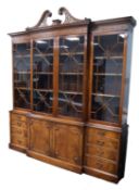 MODERN REPRODUCTION CHIPPENDALE STYLE MAHOGANY BREAKFRONT LIBRARY BOOKCASE, the pierced swan neck