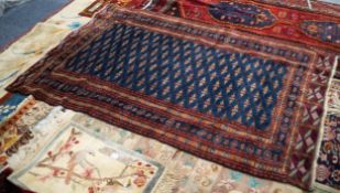 SEMI-ANTIQUE FINELY KNOTTED PERSIAN WOOL PILE RUG, the indigo field filled with multi medallions,