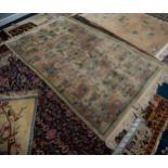 WASHED CHINESE RUG with unusual all-over embossed pattern of rectangular floral reserves, on a