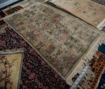 WASHED CHINESE RUG with unusual all-over embossed pattern of rectangular floral reserves, on a