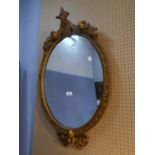 EARLY TWENTIETH CENTURY MOULDED GILT GESSO OVAL WALL MIRROR, the moulded frame moulded with