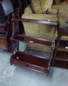 A REPRODUCTION SET OF WALL MOUNTED THREE TIER SHELVES WITH TWO SMALL BASAL DRAWERS