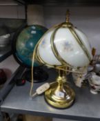 A TERRESTRIAL GLOBE, ELECTRICALLY ILLUMINATED, AND A METAL TABLE LAMP WITH HEART DECORATION AND A