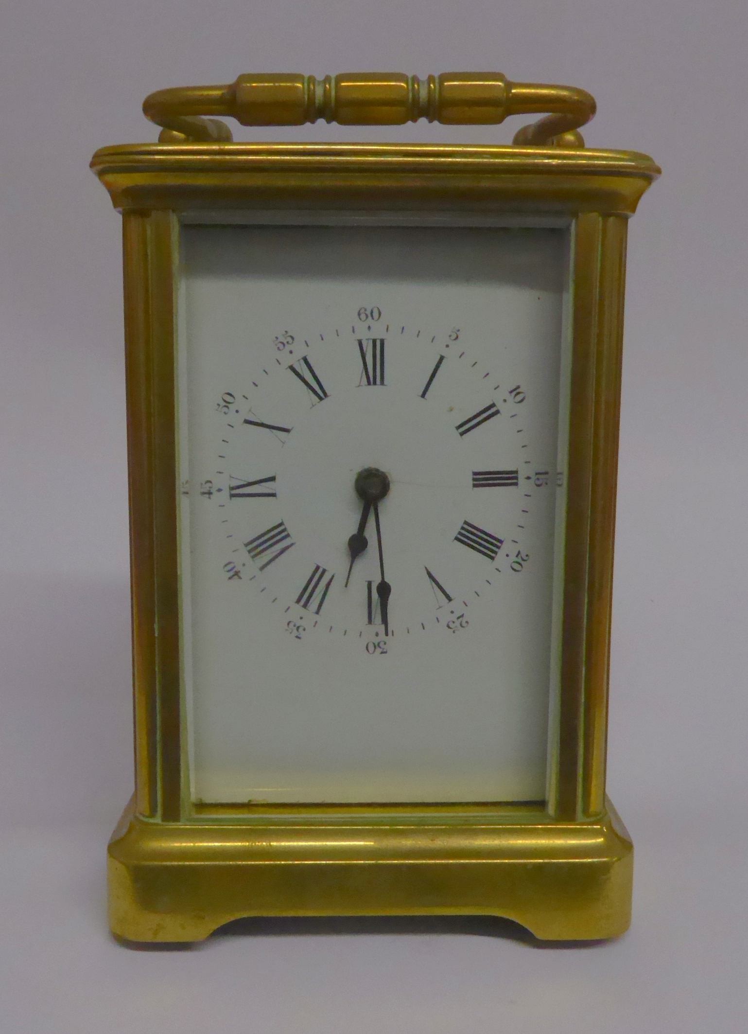 MODERN BRASS CARRIAGE CLOCK, of typical form with white mask and a moulded case with bevelled