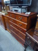 A LATE 20TH CENTURY STAINED PINE CHEST OF TWO SHORT AND FOUR GRADUATED LONG DRAWERS TO A SHAPED