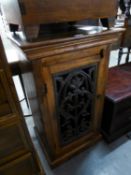 A MODERN MIDDLE EASTERN SMALL CUPBOARD, THE DOOR WITH OPEN WORK CAST PANEL, PLINTH BASE