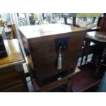 AN ORIENTAL POLISHED HARDWOOD SARCOPHAGUS FORM STORAGE BOX, WITH WROUGHT METAL HASP AND STAPLE