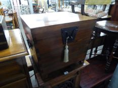 AN ORIENTAL POLISHED HARDWOOD SARCOPHAGUS FORM STORAGE BOX, WITH WROUGHT METAL HASP AND STAPLE