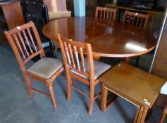 A CIRCULAR PEDESTAL DINING TABLE AND SET OF FOUR SPINDLE BACK DINING CHAIRS