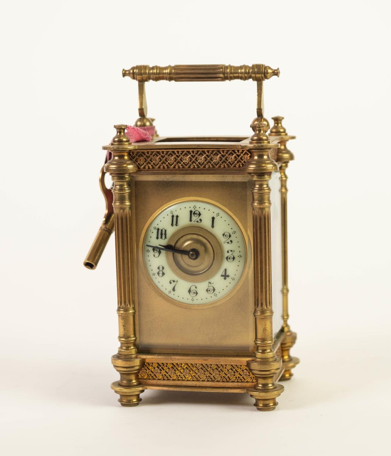 EARLY TWENTIETH CENTURY GILT BRASS CARRIAGE CLOCK, the Arabic dial with moulded gilt centre, set