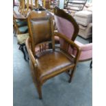 AN EARLY 20TH CENTURY, POSSIBLY CHESTNUT, ARTS & CRAFTS STYLE TUB SHAPED OPEN ARMCHAIR WITH