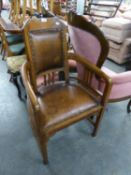 AN EARLY 20TH CENTURY, POSSIBLY CHESTNUT, ARTS & CRAFTS STYLE TUB SHAPED OPEN ARMCHAIR WITH