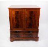 CHARLES BARR, GEORGIAN STYLE CHERRY AND FIGURED MAHOGANY TWO DOOR TELEVISION CABINET WITH FALL FRONT