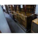 JACOBEAN STYLE CARVED OAK SIDEBOARD WITH LEDGE BACK, TWO DRAWERS OVER THREE DOORS, TWO WITH LINEN