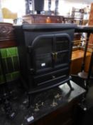 A FREE-STANDING BLACK METAL CASED ROOM HEATER, IN THE FORM OF A TWO DOOR STOVE