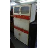 A KITCHENETTE, CREAM AND RED PAINTED WOOD