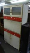 A KITCHENETTE, CREAM AND RED PAINTED WOOD