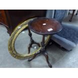 AN OVAL GILT FRAMED WALL MIRROR AND A REPRODUCTION TRIPOD WINE TABLE (2)