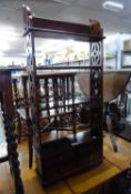 A REPRODUCTION MAHOGANY SET OF OPEN DISPLAY SHELVES WITH PIERCED SIDES AND FOUR BASAL DRAWERS