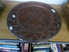 AN INDIAN EMBOSSED COPPER CIRCULAR PLAQUE