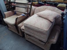 A PAIR OF LOUNGE CHAIRS, COVERED IN PINK AND WHITE FLORAL FABRIC AND MATCHING POUFFE