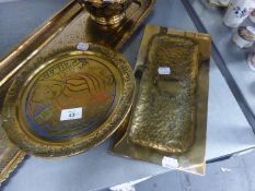 A HANDMADE BEATEN BRASS OBLONG TRAY, 12? X 6? AND AN ENGRAVED AND ENAMELLED SMALL CIRCULAR TRAY,