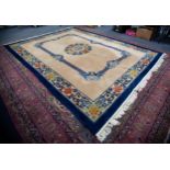 PRE-WAR CHINESE CARPET with stencilled blue key band and floral circular centre medallion and