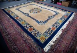 PRE-WAR CHINESE CARPET with stencilled blue key band and floral circular centre medallion and