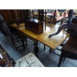 AN INTER-WAR YEARS WILLSELL PATENT OAK DRAW LEAF DINING TABLE, WITH BALUSTER TURNED SUPPORTS, 36?
