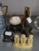 AN ORIENTAL CARVED SOAPSTONE GROUP OF THREE WISE MONKEYS; A GREEN RESIN BUDDHA; A CHINESE BLACK