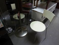 A CIRCULAR GLASS TOPPED DINING TABLE, ON METAL TUBULAR COLUMN AND CIRCULAR BASE AND A SET OF FOUR
