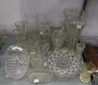 A HEAVY CUT GLASS BEAKER SHAPED VASE; TWO SMALLER CUT GLASS VASES AND OTHER GLASS  VASES ETC..