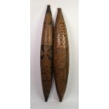 PAIR OF AFRICAN CARVED SOFTWOOD CANOE SHAPED WALL HANGINGS, worked to the exterior with geometric