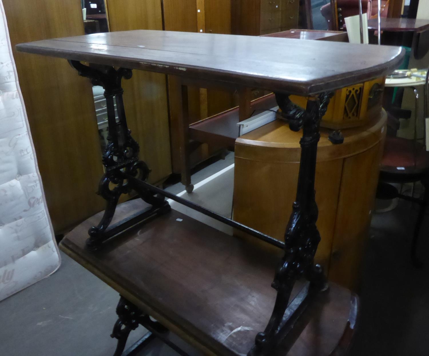 AN OBLONG CAST IRON PUB TABLE WITH WOODEN TOP