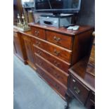 A LATE 20TH CENTURY STAINED PINE CHEST OF TWO SHORT AND FOUR GRADUATED LONG DRAWERS TO A SHAPED