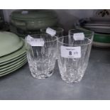 A SET OF FOUR WATERFORD CUT GLASS BARREL SHAPED TUMBLERS, BLADE CUT, WITH HEAVY DIAMOND CUT LOW BAND