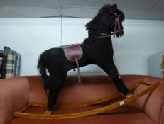 LARGE MODERN ROCKING HORSE IN BLACK ON A WOODEN FRAME