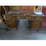 A MAHOGANY DOUBLE PEDESTAL DESK WITH SEVEN DRAWERS, ON STUMP CABRIOLE FEET (DISTRESSED)
