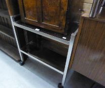 A STEEL FRAMED TWO TIER TROLLEY WITH SMOKED GLASS TOPS