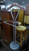 A PITCH PINE STOOL WITH CIRCULAR PANEL SEAT, ON FOUR POST SUPPORTS WITH STRETCHER RAILS AND A GENT?S