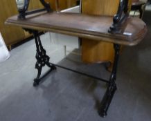 AN OBLONG CAST IRON PUB TABLE WITH WOODEN TOP