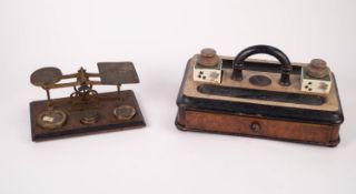 PAIR OF EARLY TWENTIETH CENTURY BRASS POSTAL SCALES, on oblong stained wood base with  SET OF FIVE