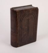 EARLY EIGHTEENTH CENTURY RUSTIC COVERED OAK PUZZLE BOX IN THE FORM OF A BIBLE, with incise carved