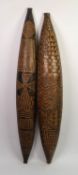 PAIR OF AFRICAN CARVED SOFTWOOD CANOE SHAPED WALL HANGINGS, worked to the exterior with geometric